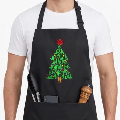 Tablier de cuisine noir avec un sapin de Noël Sexy formé de silhouettes vertes et de cœurs rouges et jaunes.
