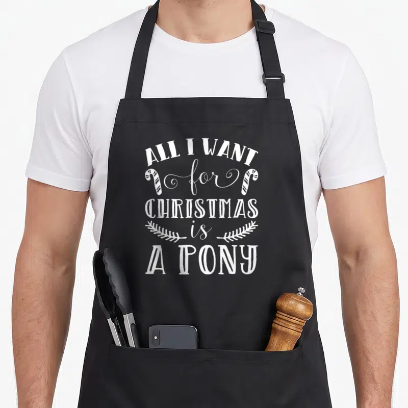 Tablier de cuisine noir avec inscription blanche Tout ce que je veux pour Noël est un poney et deux cannes à sucre.