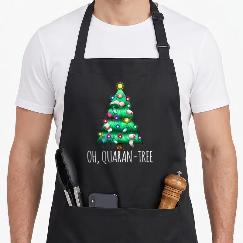 Tablier de cuisine noir avec un arbre de Noël décoré de papier hygiénique et de masques sous le texte OH, QUARAN-TREE.