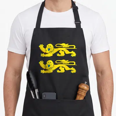 Tablier de cuisine noir avec deux lions jaunes stylisés en position passante sur fond rouge vif.