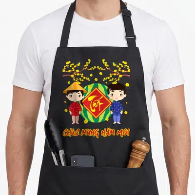 Tablier de cuisine noir avec deux enfants vietnamiens, un melon et des fleurs jaunes.