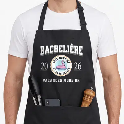 Tablier de cuisine noir avec inscription Bachelière 2026 et illustration de flamant rose gonflable sur l'eau.