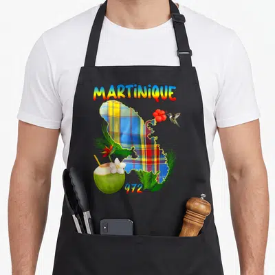 Tablier de cuisine noir avec carte Martinique madras, colibri, coco et fleurs tropicales colorées.