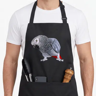 Tablier de cuisine noir avec illustration détaillée d'un perroquet gris africain aux plumes texturées et à la queue rouge.