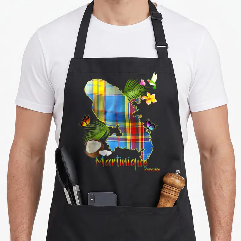 Tablier de cuisine noir avec carte Martinique en madras, colibri, papillons et cocotier imprimé.
