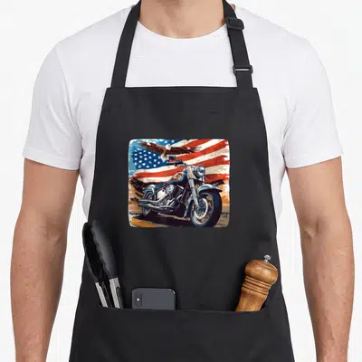 Tablier de cuisine noir avec illustration moto américaine, aigle en vol et drapeau aux couleurs vives.