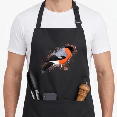 Tablier de cuisine noir avec illustration colorée d'un bouvreuil rouge et gris entouré d'éclaboussures artistiques.