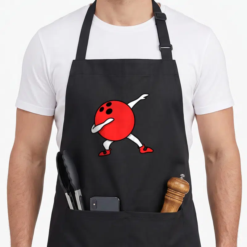Tablier de cuisine noir avec une boule de bowling rouge anthropomorphisée effectuant un mouvement de danse.