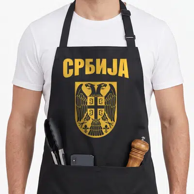 Tablier de cuisine noir avec linscription JA et un aigle bicéphale doré sur fond décusson.