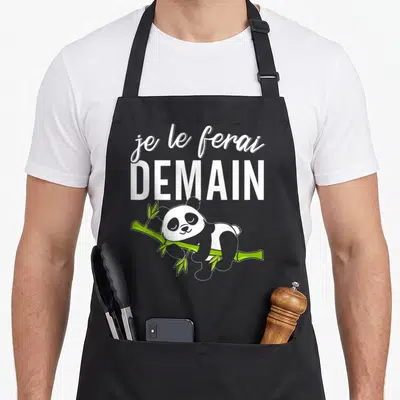 Tablier de cuisine noir avec un panda dormant sur une tige de bambou vert et le texte blanc je le ferai demain