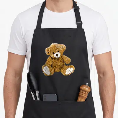 Tablier de cuisine noir avec illustration d'un ours en peluche marron aux pattes blanches assis face à l'utilisateur.
