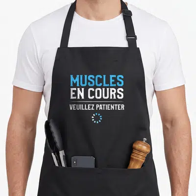 Tablier de cuisine noir avec le texte Muscles en cours veuillez patienter et une barre de chargement bleue.