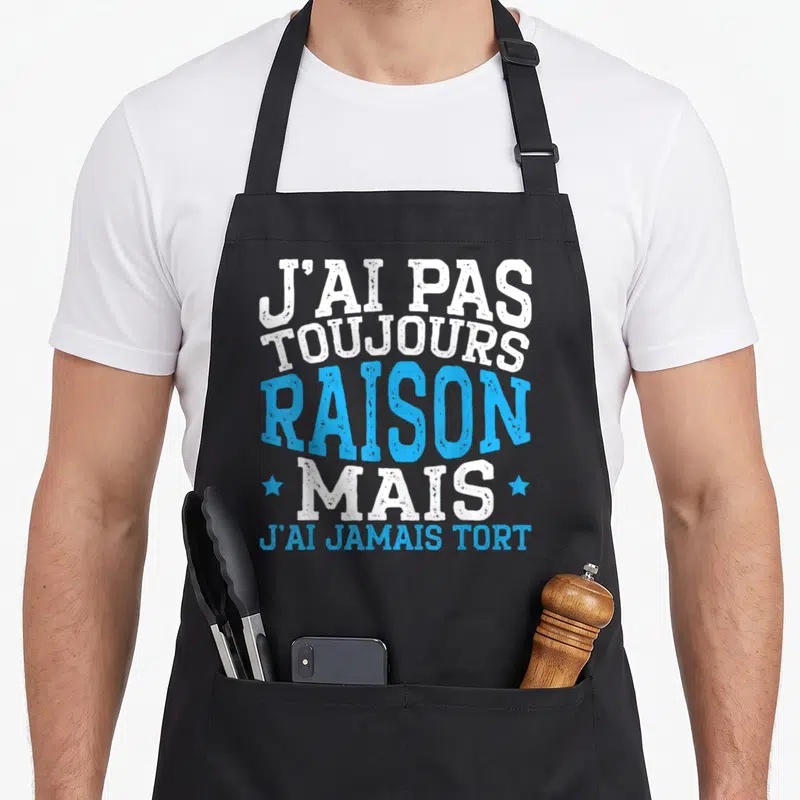 Tablier de cuisine noir avec inscription J'ai pas toujours raison mais j'ai jamais tort en blanc et bleu.