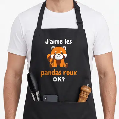 Tablier de cuisine noir avec un panda roux mignon et le texte J'aime les pandas roux OK ? imprimé en orange et blanc.