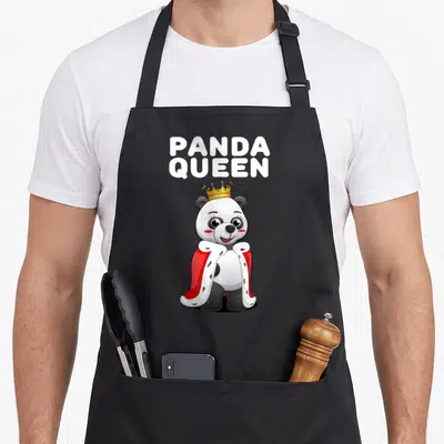 Tablier de cuisine noir avec un panda royal portant une couronne dorée et une cape rouge à col blanc.
