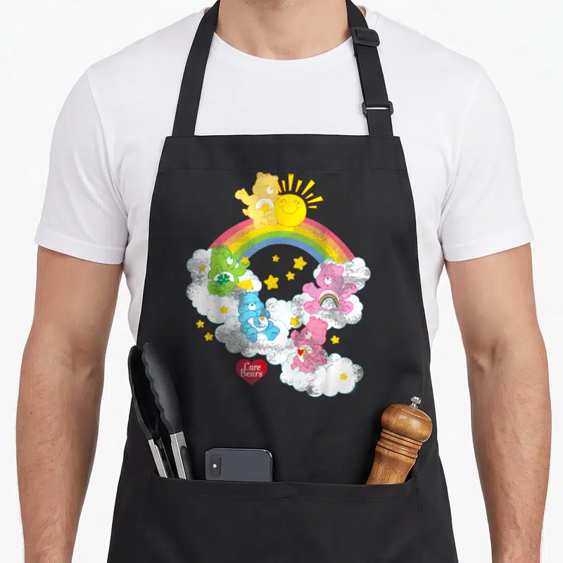 Tablier de cuisine noir avec ours du assis sur des nuages, un arc-en-ciel et un soleil souriant.