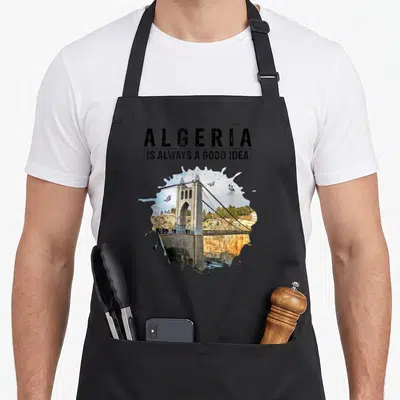 Tablier de cuisine noir avec illustration du pont Sidi M'Cid, papillons volants et texte Algeria is always a good idea.