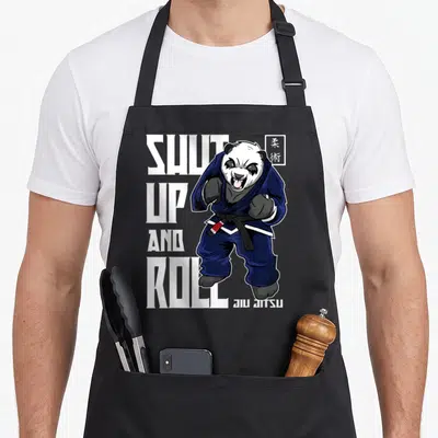 Tablier de cuisine noir avec un panda en gi bleu et le texte Shut Up and Roll