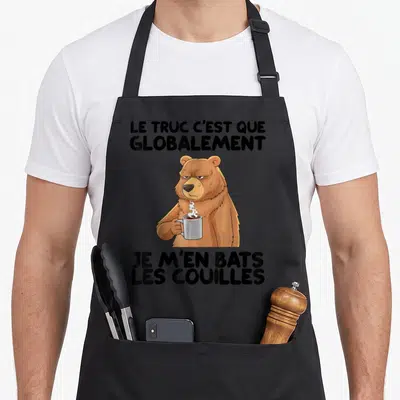 Tablier de cuisine noir avec illustration d'un ours tenant une tasse et texte humoristique en noir.