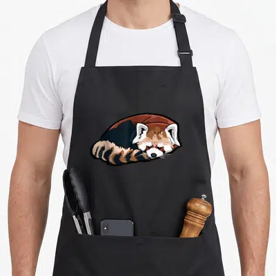 Tablier de cuisine noir avec illustration d'un panda rouge couché en train de dormir paisiblement.