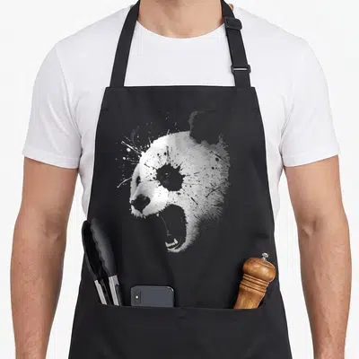Tablier de cuisine noir avec tête d'ours panda en grognement style éclaboussure graphique.