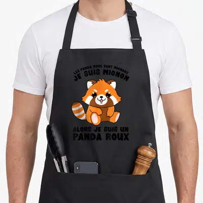 Tablier de cuisine noir avec illustration d'un panda roux mignon et texte humoristique en français.