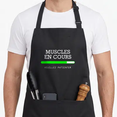 Tablier de cuisine noir avec texte blanc muscles en cours et barre de chargement verte.
