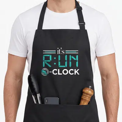 Tablier de cuisine noir avec l'inscription It's Run O-Clock en turquoise et blanc, incluant une icône de chaussure de sport.
