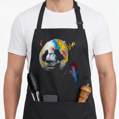 Tablier de cuisine noir avec tête de panda peinte en bleu, jaune et rouge.