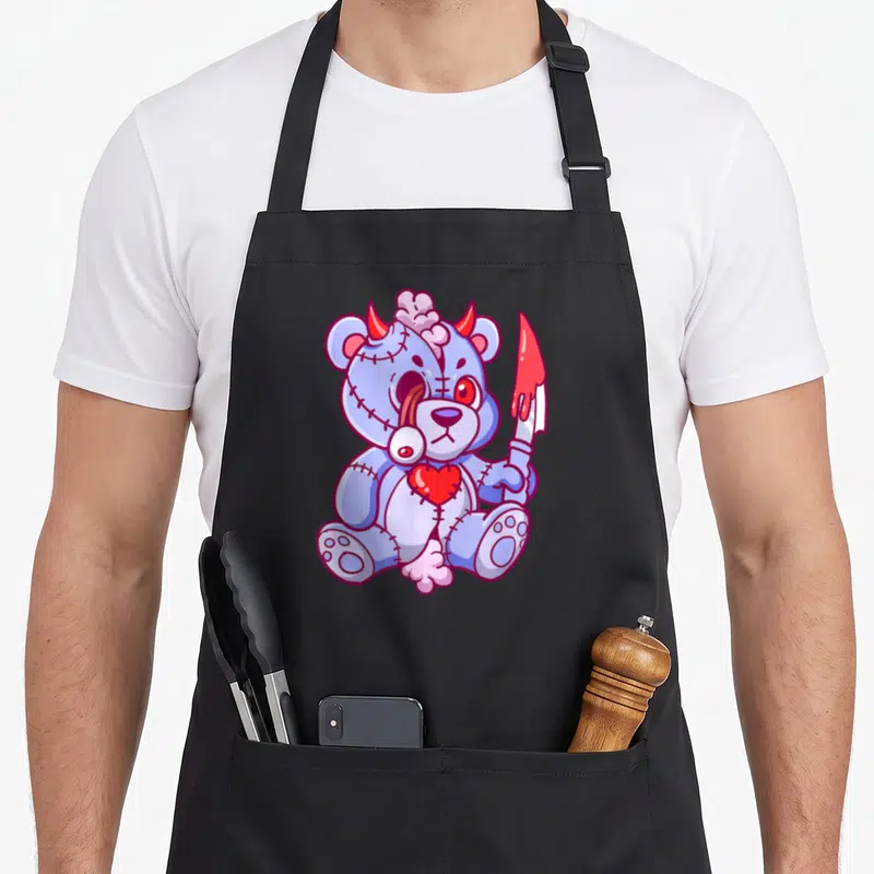 Tablier de cuisine noir avec ours en peluche pastel goth creep kawaii tenant un couteau.