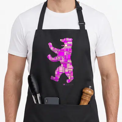 Tablier de cuisine noir avec silhouette d'ours stylisée en rectangles roses et texte I Love Berlin en bas à droite.
