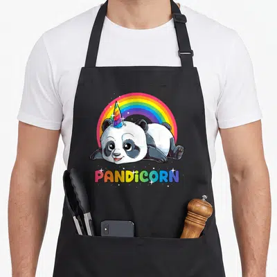 Tablier de cuisine noir avec un panda licorne aux couleurs vives et un arc-en-ciel en arrière-plan.