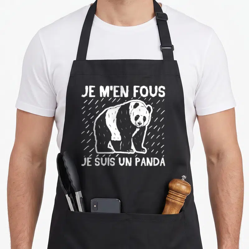 Tablier de cuisine noir avec illustration d'un panda et le texte Je m'en fous je suis un panda en blanc.