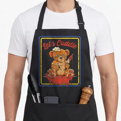Tablier de cuisine noir avec ours en peluche effrayant tenant un couteau ensanglanté sous le texte Let's Cuddle.