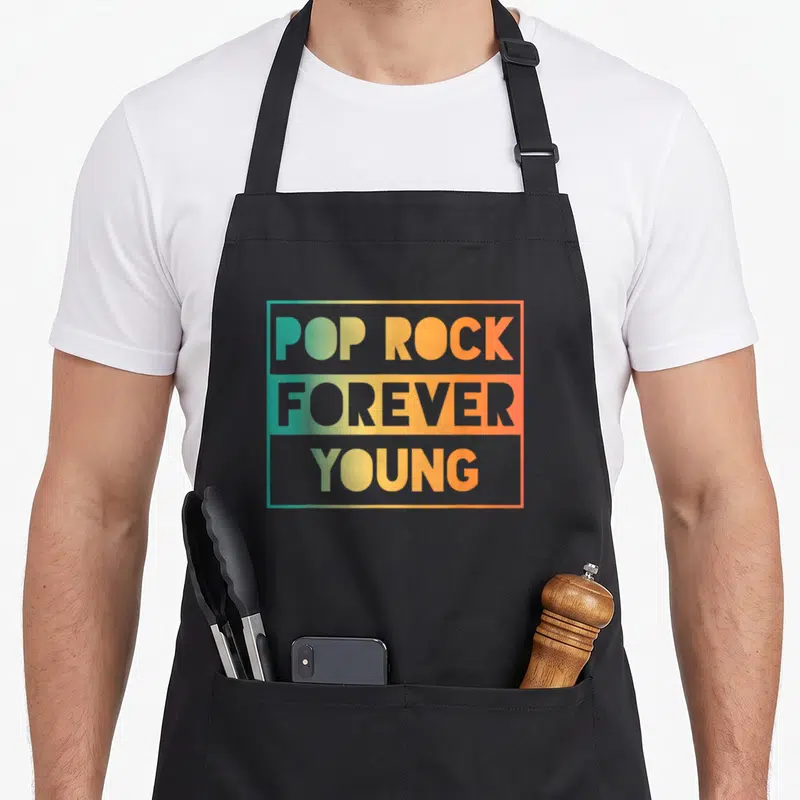 Tablier de cuisine noir avec inscription Pop Rock Forever Young en lettres colorées sur fond rectangulaire dégradé.