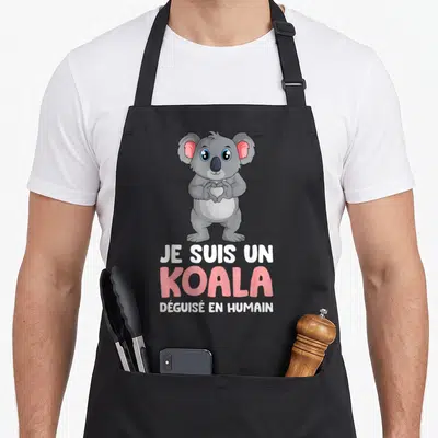 Tablier de cuisine noir avec illustration d'un koala gris formant un cœur et texte blanc rose