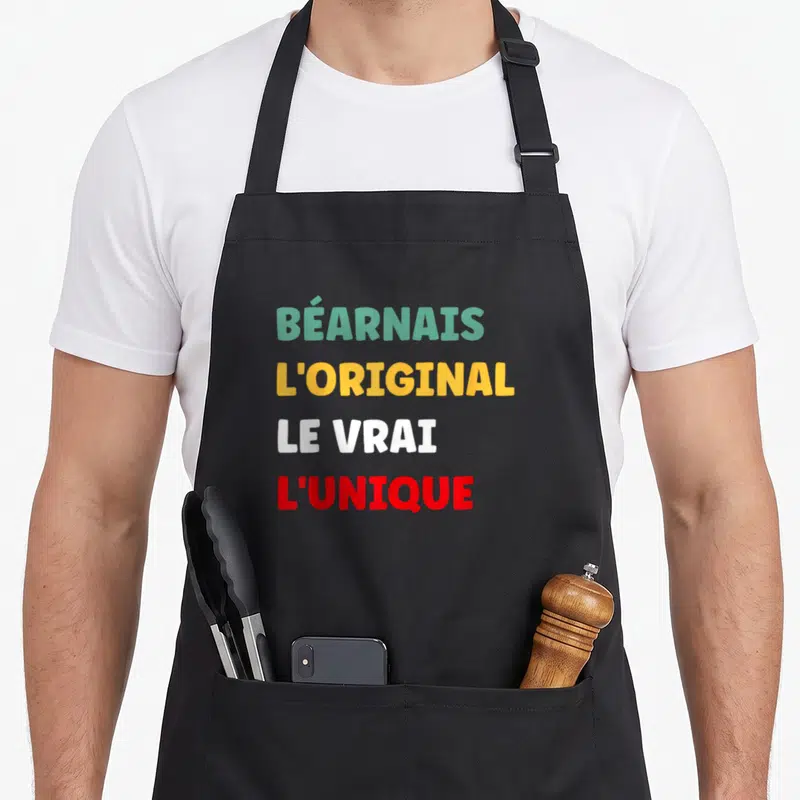 Tablier de cuisine noir avec le texte BÉARNAIS L'ORIGINAL LE VRAI L'UNIQUE en couleurs vives.