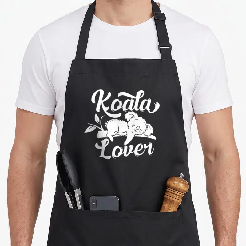 Tablier de cuisine noir avec illustration blanche d'un koala dormant et le texte « Koala Amoureux ».