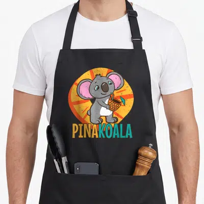 Tablier de cuisine noir avec illustration d'un koala tenant un verre d'ananas et le texte PINAKOALA.
