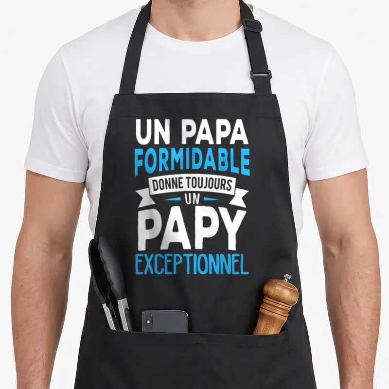Tablier de cuisine noir avec inscription Un Papa Formidable Donne Toujours Un Papy Exceptionnel en blanc et bleu.