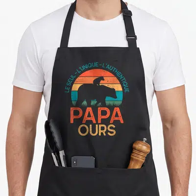 Tablier de cuisine noir avec silhouette d'ours orange et texte Papa Ours sur fond de soleil retro