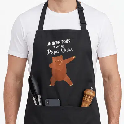 Tablier de cuisine noir avec un ours brun effectuant la pose dab et le texte blanc Je m'en fous je suis un papa ours.