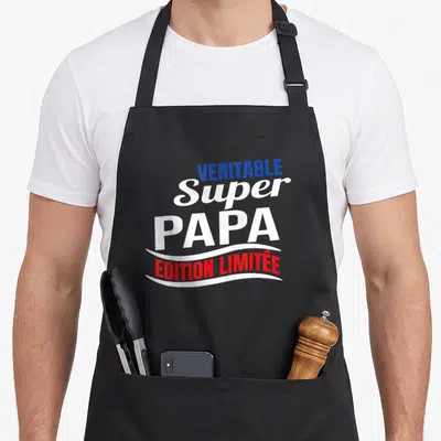Tablier de cuisine noir avec l'inscription Véritable Super Papa « Édition Limitée » en bleu, blanc et rouge.
