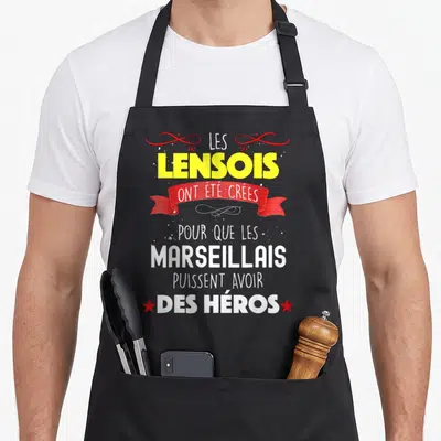 Tablier de cuisine noir avec le texte Les Lensois ont été créés pour que les Marseillais puissent avoir des héros en jaune et blanc.