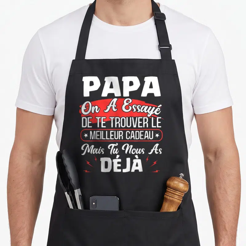 Tablier de cuisine noir avec l'inscription Papa on a essayé de te trouver le meilleur cadeau mais tu nous as déjà en blanc et rouge.
