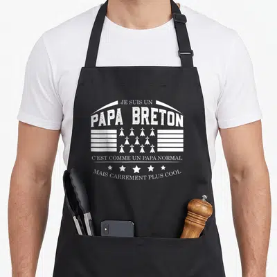 Tablier de cuisine noir avec inscription Je Suis Un Papa Breton et drapeau gwer mod blanc stylisé.