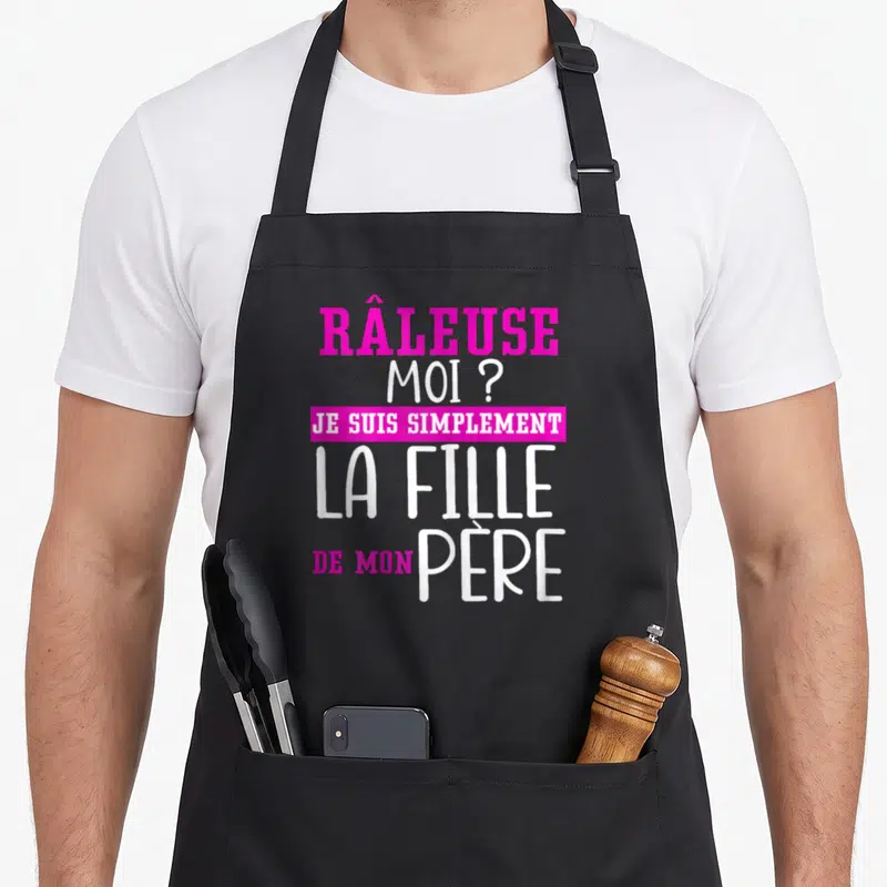 Tablier de cuisine noir avec inscription rose et blanche râleuse moi je suis simplement la fille de mon père.