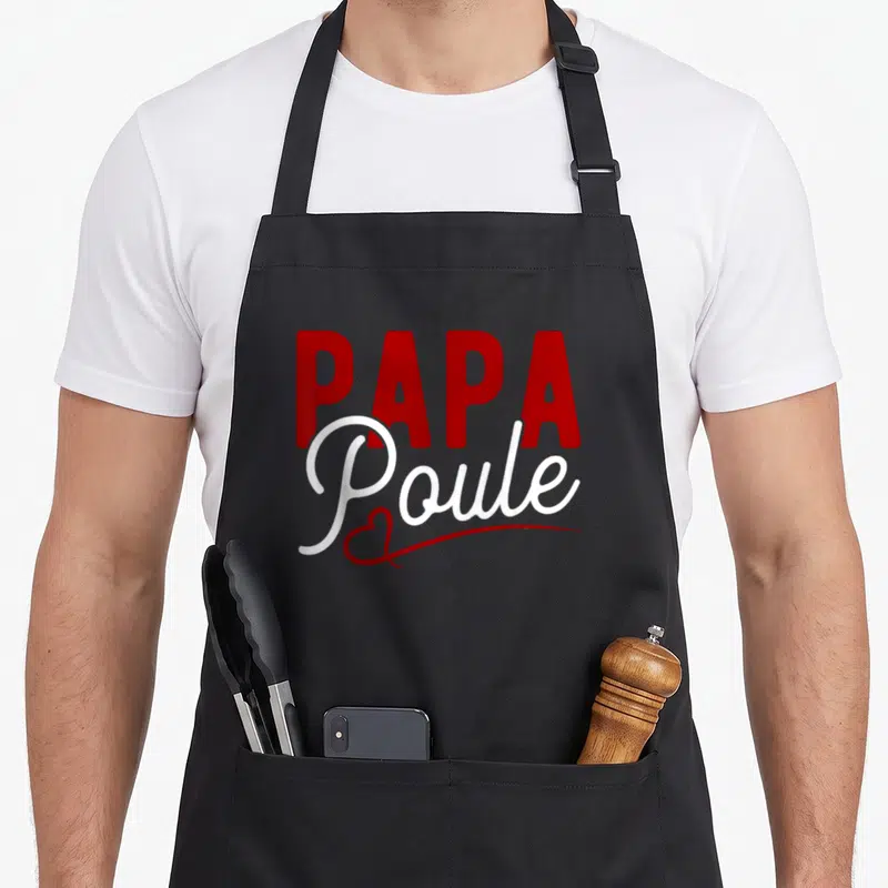 Tablier de cuisine noir avec inscription Papa Poule en rouge et blanc stylisé.