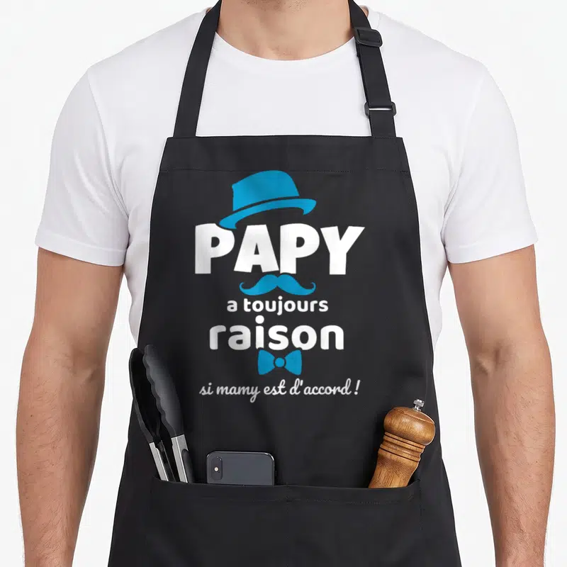 Tablier de cuisine noir avec l'inscription Papy a toujours raison et des éléments graphiques bleus élégants.
