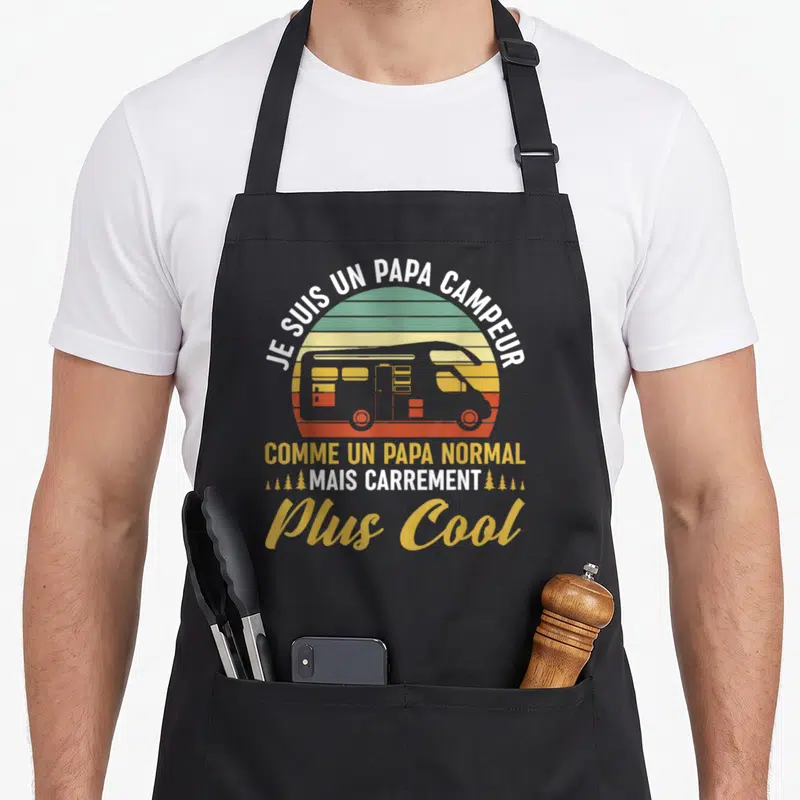 Tablier de cuisine noir avec illustration camping-car et texte Je suis un papa campeur mais carrement plus cool.